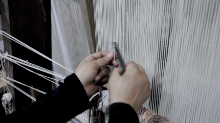 A woman weaves on a loom, World Bank Photo Collection, CC BY-NC-ND 2.0